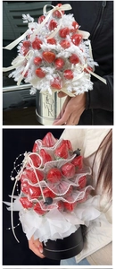 Detail of round mini flower box with fresh strawberries, white lace and pearl accents