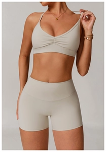 Detail of V-neck quick-dry yoga bra with pleated front and high-waist biker shorts