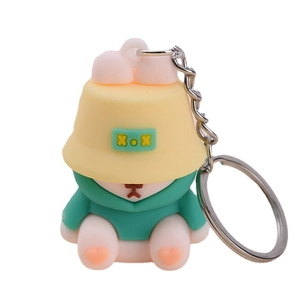 Cute cartoon rabbit PVC keychain with yellow hat and green hoodie on white background