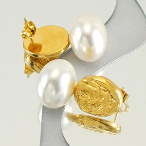 Macro detail of French vintage pearl earrings with gold textured lava metal finish