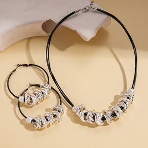 Detailed set of multi-layer silver metal ring necklace and earrings with black cord