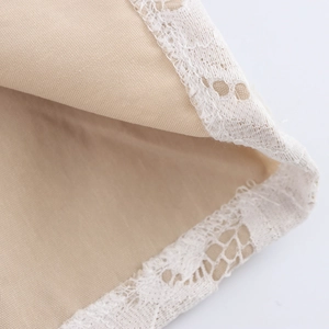 Elegant beige lace set featuring a cropped cardigan and skirt with intricate floral trim