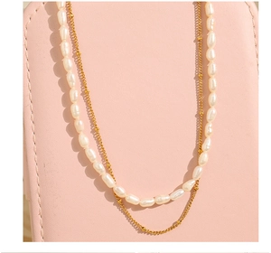 Detail of double-layer necklace with irregular freshwater pearls and gold metal chain