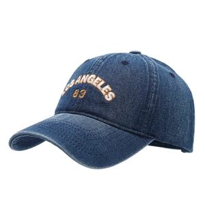 Navy denim baseball cap with Los Angeles embroidery and curved brim in side-front view