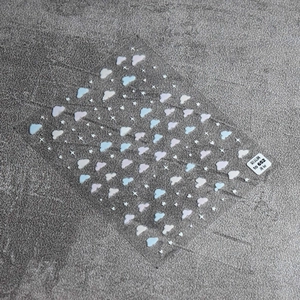 Detail showing self-adhesive nail stickers with white stars and blue gradient clouds