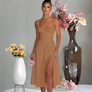 Close-up of khaki midi dress featuring a bustier bodice with lace-up detail and side slit
