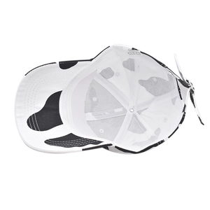 Detailed inner view of cow print cotton baseball cap showing 100% cotton label and stitching