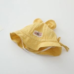 Detail of yellow baby sun hat with 3D ears, rabbit embroidery, and adjustable chin strap