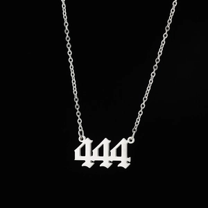 Close-up of polished stainless steel angel number 444 pendant with gothic style chain