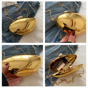 Detailed views of gold metallic mango-shaped evening bag with chain strap and mirror finish