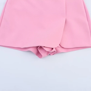 Detail of pink skort showing split hem design and smooth polyester blend fabric