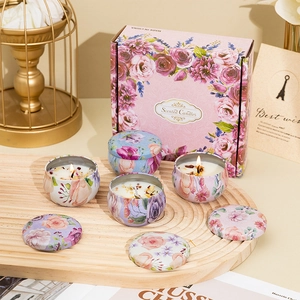 Detail of floral metal candle tins with dried flower petals inside a gift box