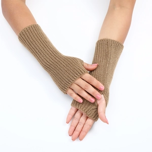 Detail of light brown ribbed knit fingerless gloves showing soft texture on arms