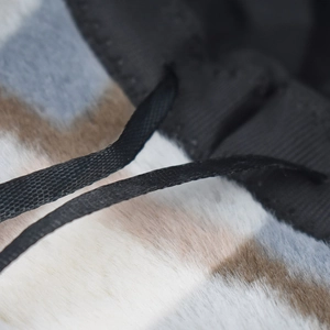 Close-up of fuzzy winter bucket hat showing camouflage faux fur texture and black drawstring