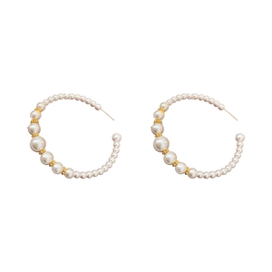 French vintage gold C-shaped hoop earrings with graduated white pearls on a white background