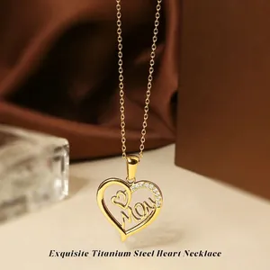 Detailed close-up of 18K gold titanium steel heart pendant with Mom engraving and zircons