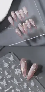 Detail of 5D white butterfly nail stickers and pink gradient press-on nails with pearls