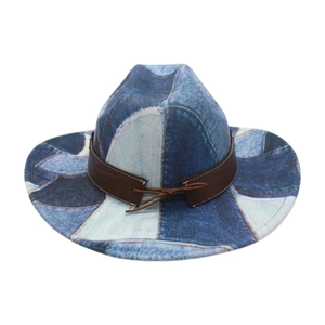 Close-up of patchwork denim style cowboy hat featuring a brown leather decorative band