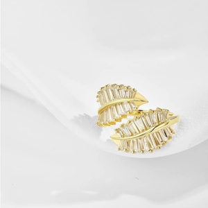 Macro shot of gold leaf-shaped ring featuring sparkling marquise cubic zirconia accents