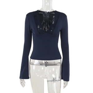 Detailed view of dark blue slim knit top with deep V-neck and delicate lace trim