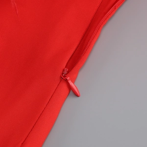 Detailed close-up of a high-quality invisible zipper on a red bandage party dress fabric