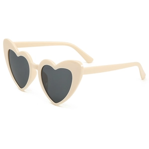 Trendy cream heart shaped sunglasses with dark UV400 lenses in a stylish tilted view