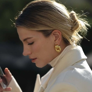 Chunky gold-plated twisted knot hoop earrings featuring a stylish wrinkled texture for women