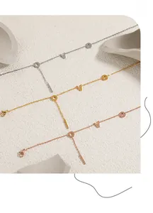 Detailed close-up of LOVE letters on gold, silver and rose gold titanium steel anklets