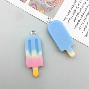 Detail of colorful resin gradient ice cream pendants with silver metal rings for DIY jewelry