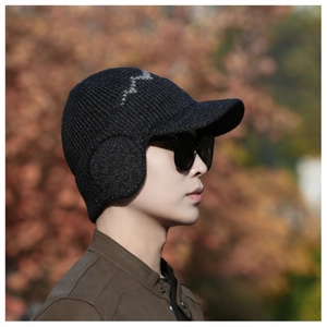 Side view of men's thick knitted winter hat with ear flaps and peak in black color