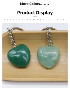 Detail of heart-shaped natural stone keychains in dark and light green with silver rings