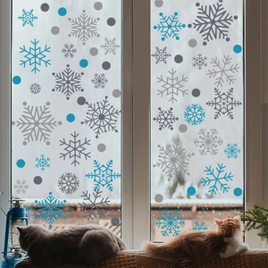 Winter window decals featuring blue and silver snowflakes with cozy cats on a snowy window