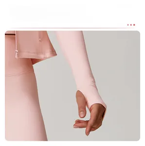 Close-up of pink fitness jacket sleeve showing the functional thumb hole design