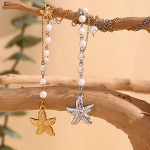 Vintage 18K gold and silver plated starfish pearl pendant necklaces on a tree branch