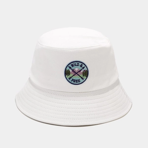 Detail shot of the white cotton bucket hat featuring a Wild & Free embroidered patch