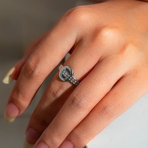 Close-up of silver geometric ring with star-shaped sparkling zirconia on female hand