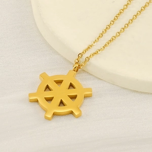 18K gold plated stainless steel star chart rudder necklace on a minimalist pedestal