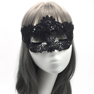 Detailed view of black lace eye mask with intricate floral patterns on a white mannequin
