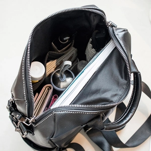 Black leather backpack with large capacity and organized compartments for travel or school