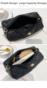 Detail view showing large capacity storage for cosmetics in black quilted cylinder bag