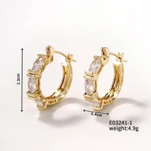 Macro view of gold-plated hoop earrings with marquise-cut cubic zirconia crystals
