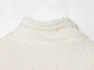 Detailed close-up of white fleece texture and collar on soft winter cotton coat
