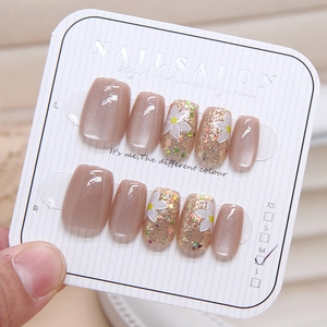 Pink cat eye press-on nails with white floral patterns and sparkling glitter finish
