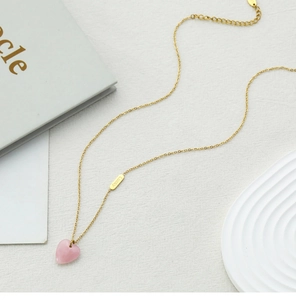 Close-up of pink quartz heart pendant with Lucky tag and 18K gold plated chain