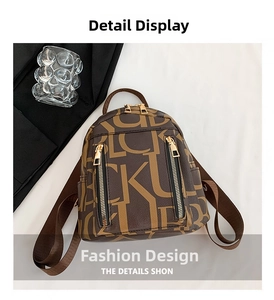 Detail view of large capacity vintage brown leather backpack with letter patterns and zippers
