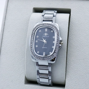 Detailed view of silver oval quartz watch with rhinestones in a gray velvet gift box