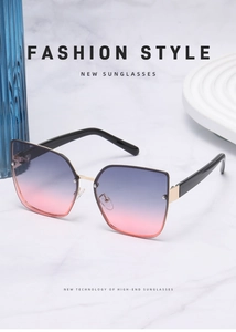 Detail of oversized cat-eye sunglasses with gradient lenses and gold metal hinges