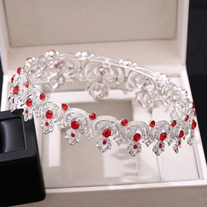Detail view of a vintage bridal tiara with red crystals and rhinestones in a white gift box