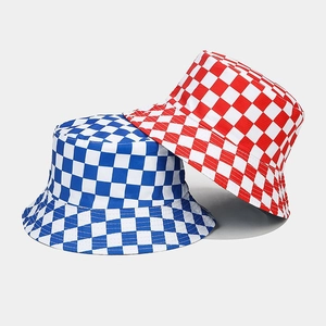 Detail of blue and red checkered bucket hats showing reversible canvas fabric and patterns