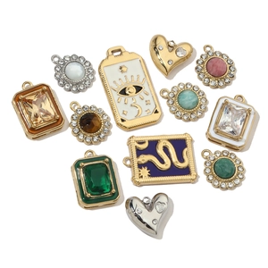 Detailed assortment of geometric stainless steel pendants with enamel and natural stone details